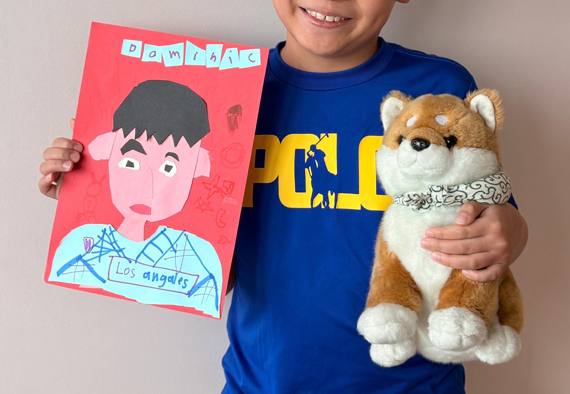 Child holding a plush toy and a coloring book with a bear illustration.